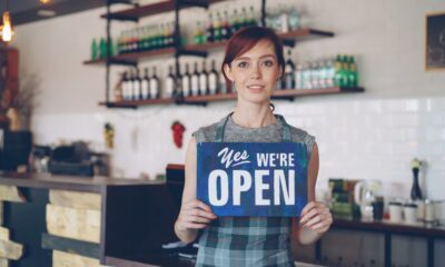 Small business owner welcoming new customers while learning how to get more customers for my small business