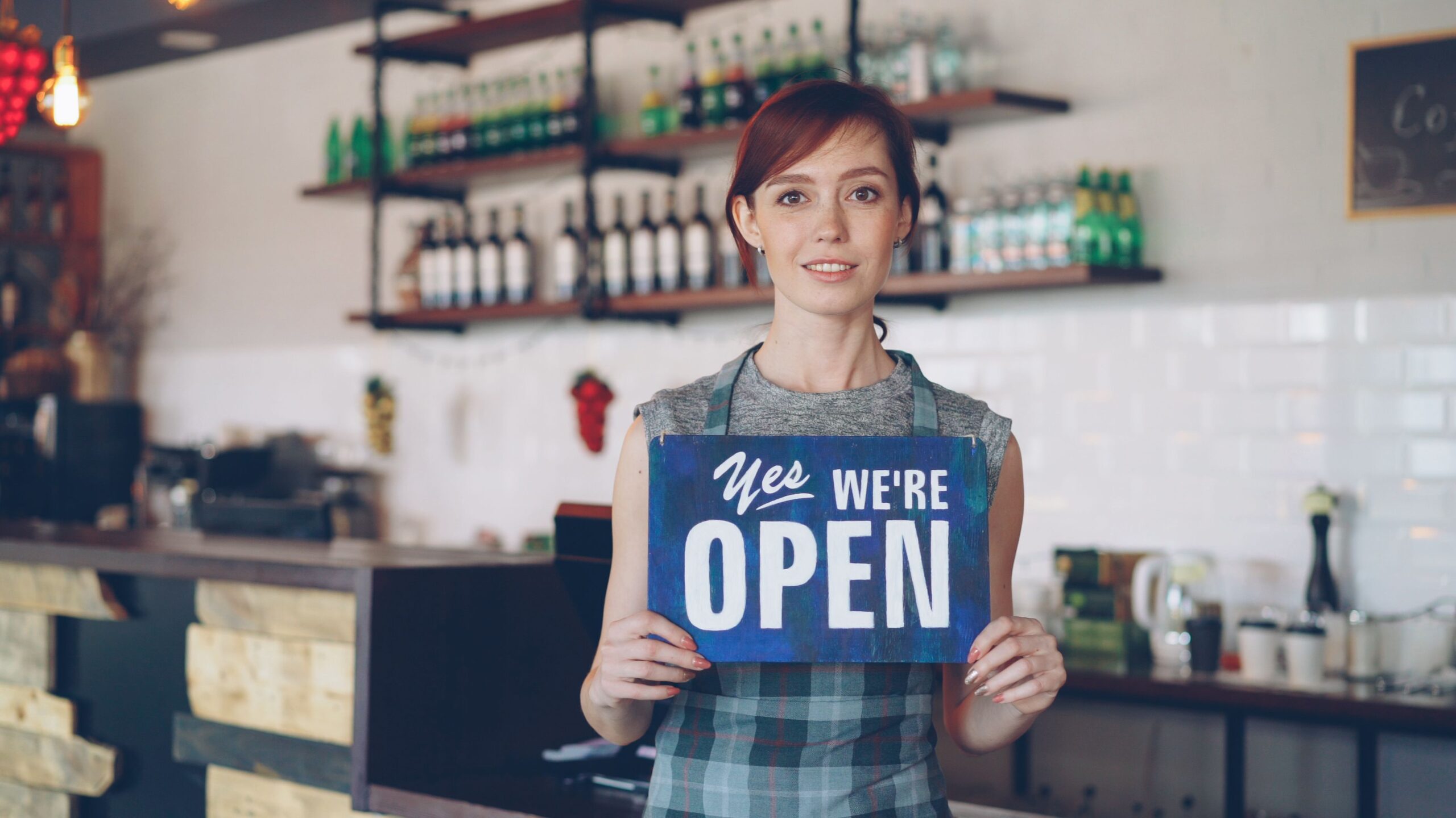 Small business owner welcoming new customers while learning how to get more customers for my small business