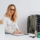 Small business owner planning how to run a successful small business at a desk with a laptop and notebook