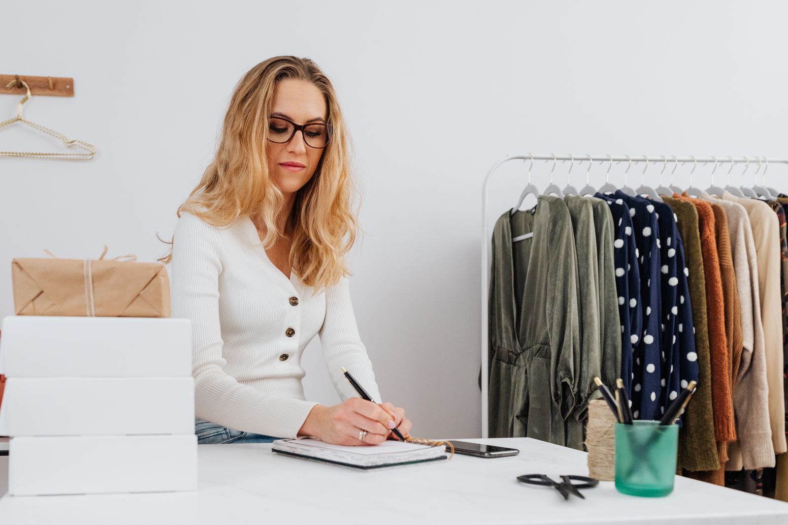 Small business owner planning how to run a successful small business at a desk with a laptop and notebook