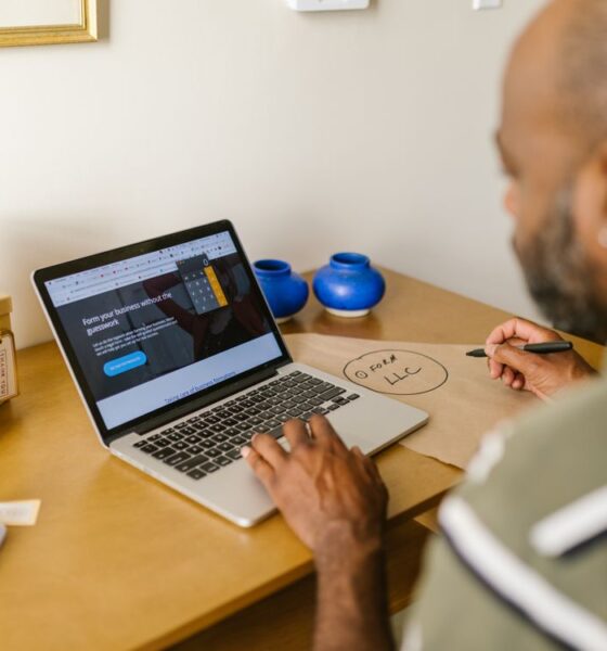 How to Write an Overdue Invoice Reminder Email That Gets Paid Without Damaging the Relationship 42 A small business owner writing an overdue invoice reminder email on a laptop.