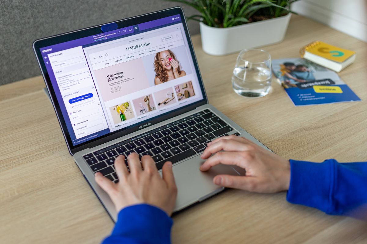 How to Make a Website for Small Business: A Simple Guide That Gets You Online 42 A laptop showing a website builder while a small business owner designs a website